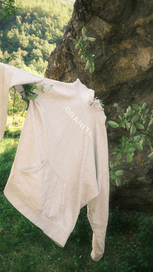 Grey GRANITE.Core HOODIE hanging on a tree in a bouldering area in Norway